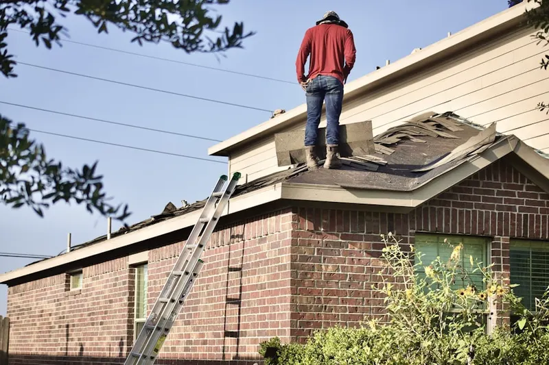 Professional roofer working on a residential roof in Scott Corners